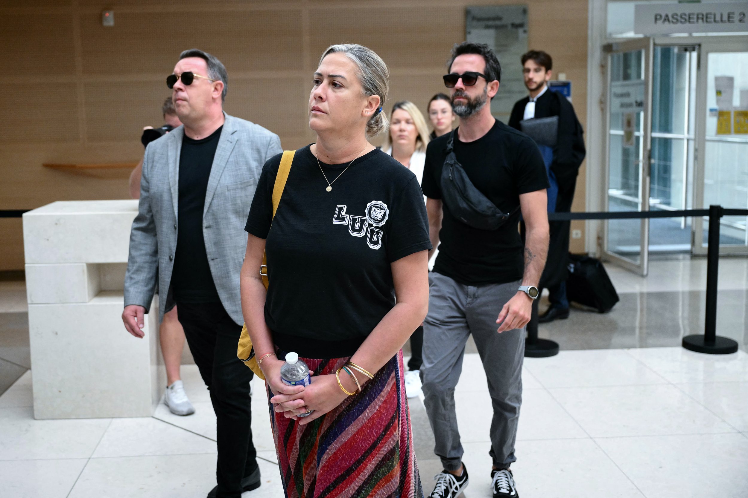The son of Gisele P., Florian P. (R) and her daughter Caroline Darian (C) arrive at the courthouse during the trial